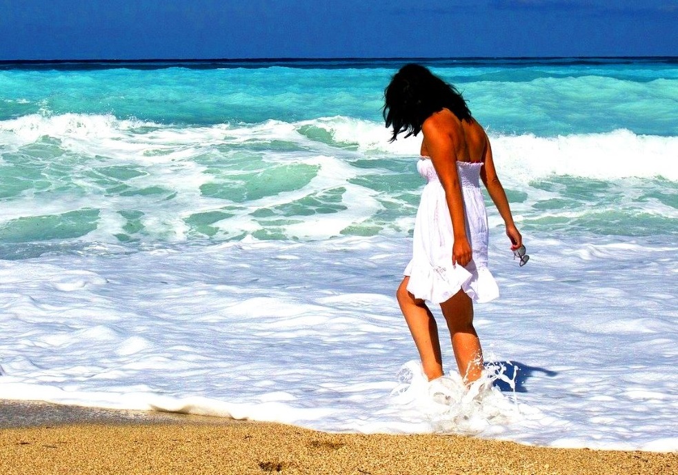 Solo female traveler on tropical beach
