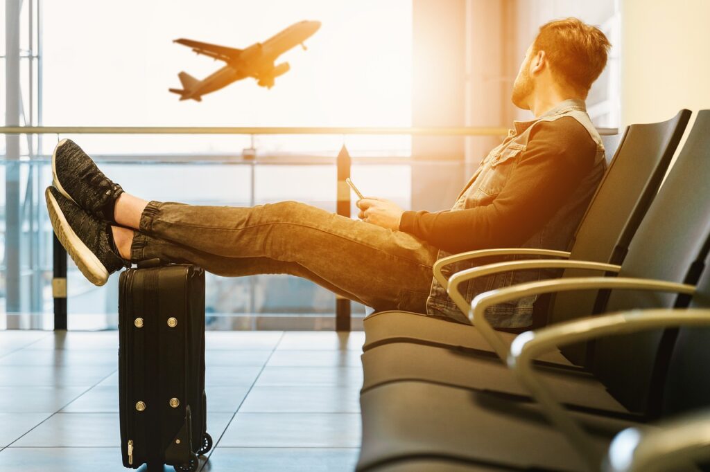 Solo male traveler with luggage at airport
