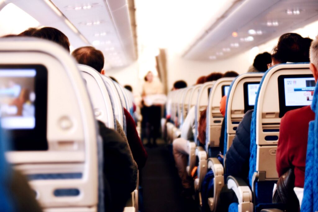 Economy class section inside a commercial airplane cabin