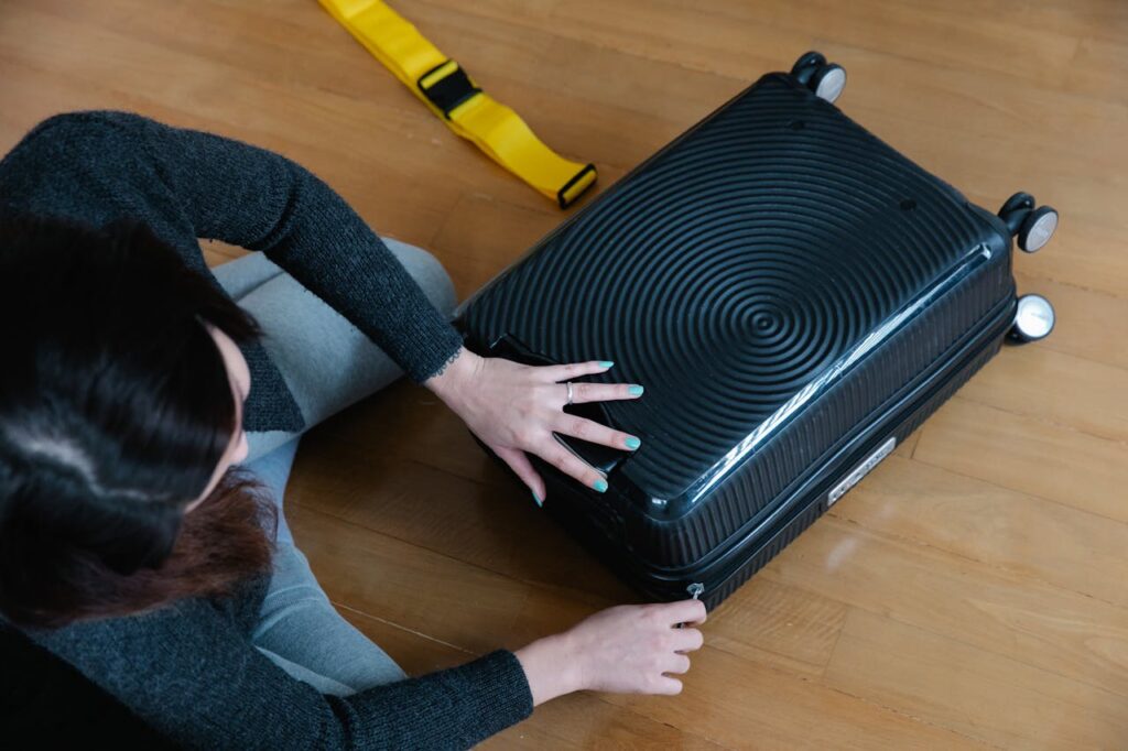 woman closing a carry-on